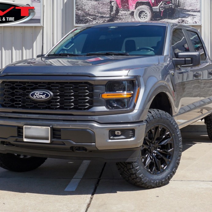 Gray 2024 Ford F150 STX with Rough Country Level on 20x9 Fuel Off-Road D804 Flame Wheels in Blackout & 35x11.50R20 Nitto Recon Grappler Tires
